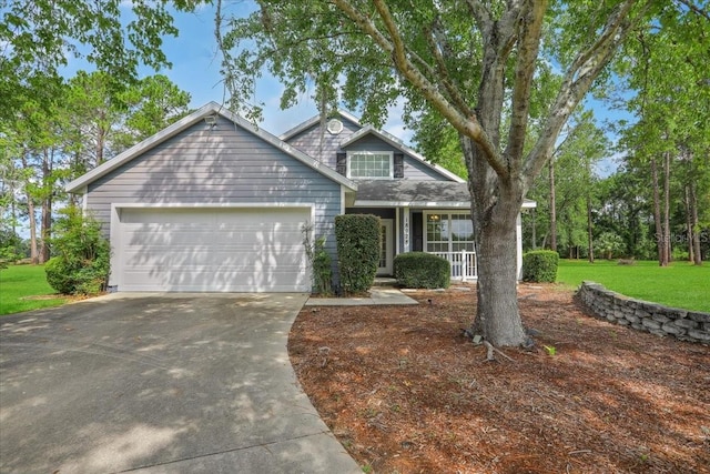 18028 NW 177th Ave, Alachua, FL 32615 - traditional-style house featuring driveway, a garage, a front yard, and a porch