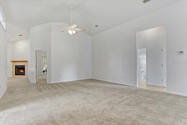 18028 NW 177th Ave, Alachua, FL 32615 - unfurnished living room featuring light colored carpet, a ceiling fan, high vaulted ceiling, a fireplace, and baseboards