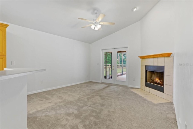 18028 NW 177th Ave, Alachua, FL 32615 - unfurnished living room with carpet floors, a tiled fireplace, a ceiling fan, baseboards, and high vaulted ceiling