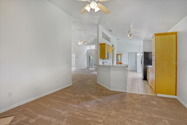 18028 NW 177th Ave, Alachua, FL 32615 - kitchen with ceiling fan, light colored carpet, freestanding refrigerator, white microwave, and open floor plan