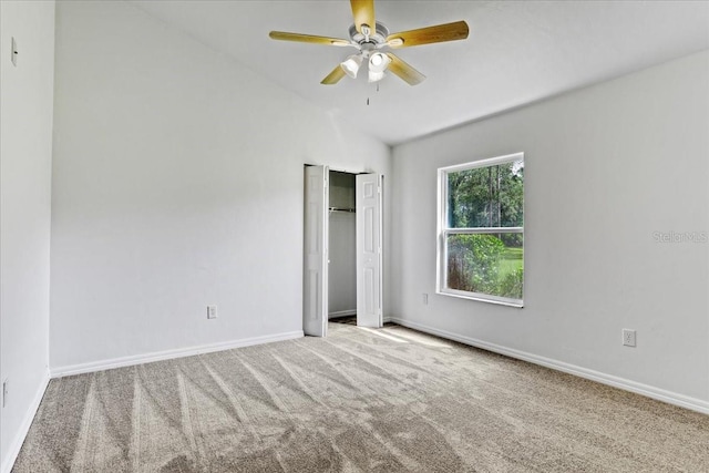 18028 NW 177th Ave, Alachua, FL 32615 - unfurnished bedroom with carpet flooring, vaulted ceiling, baseboards, a closet, and a ceiling fan