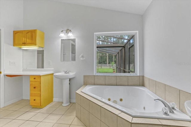 18028 NW 177th Ave, Alachua, FL 32615 - full bathroom featuring a whirlpool tub, tile patterned flooring, and baseboards
