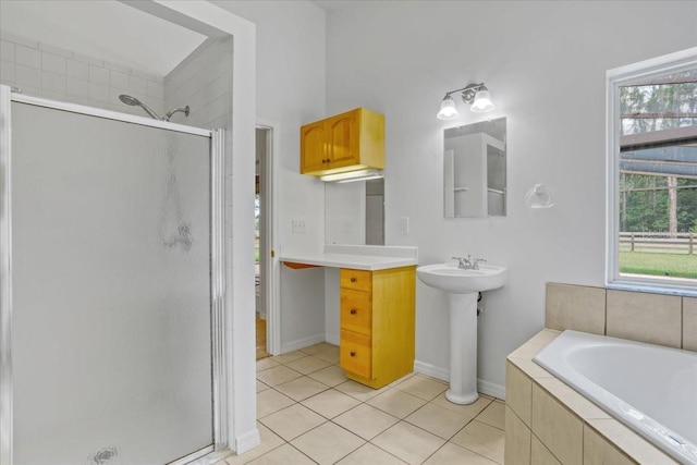 18028 NW 177th Ave, Alachua, FL 32615 - bathroom with a stall shower, tile patterned floors, a garden tub, baseboards, and a sink