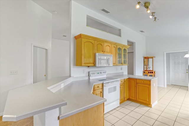 18028 NW 177th Ave, Alachua, FL 32615 - kitchen with white appliances, a peninsula, light tile patterned floors, light countertops, and glass insert cabinets