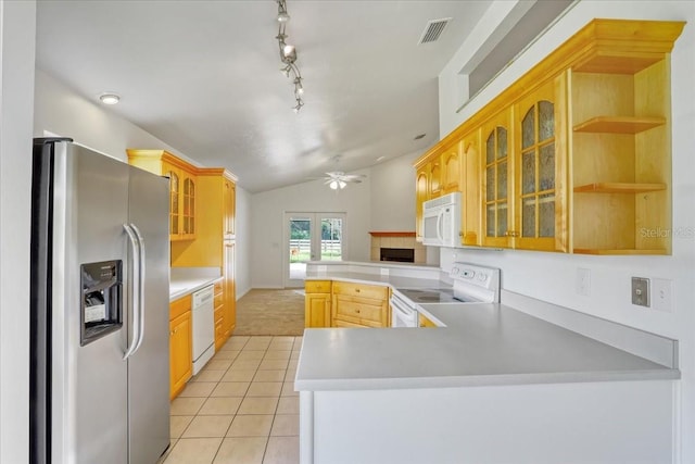 18028 NW 177th Ave, Alachua, FL 32615 - kitchen with white appliances, a peninsula, vaulted ceiling, light tile patterned floors, and a ceiling fan