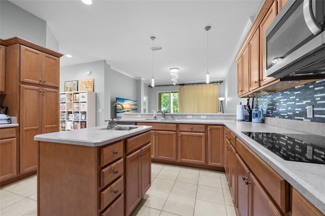 6516 NW 109th Pl, Alachua, FL 32615 - kitchen featuring stainless steel microwave, black electric stovetop, a sink, brown cabinetry, and recessed lighting