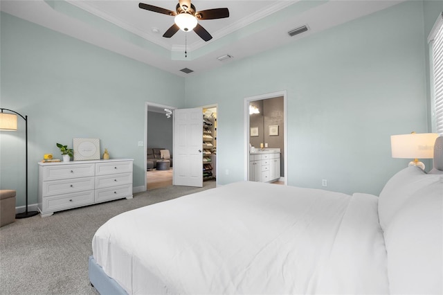 6516 NW 109th Pl, Alachua, FL 32615 - bedroom with carpet flooring, ornamental molding, a walk in closet, connected bathroom, and a ceiling fan