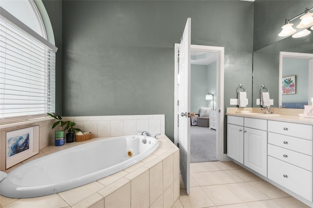 6516 NW 109th Pl, Alachua, FL 32615 - full bath with vanity, a tub with jets, connected bathroom, tile patterned flooring, and a towering ceiling