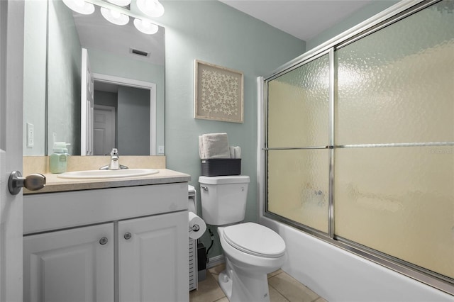6516 NW 109th Pl, Alachua, FL 32615 - bathroom featuring toilet, vanity, shower / bath combination with glass door, and tile patterned floors