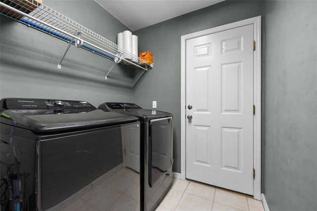 6516 NW 109th Pl, Alachua, FL 32615 - laundry room featuring washing machine and clothes dryer, baseboards, and light tile patterned floors