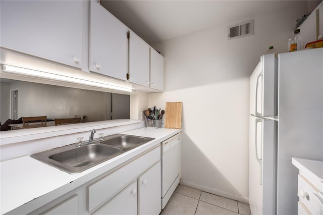 3921 SW 34th St Unit 106, Gainesville, FL 32608 - kitchen featuring white appliances, light tile patterned floors, light countertops, and white cabinetry