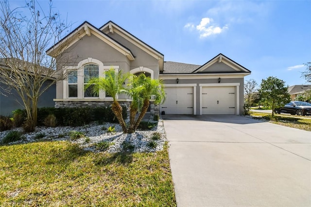 13201 Orca Sound Dr, Riverview, FL 33579 - ranch-style home with a garage, concrete driveway, stucco siding, and stone siding