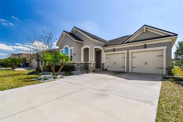 13201 Orca Sound Dr, Riverview, FL 33579 - view of front of property with stucco siding, an attached garage, driveway, and stone siding