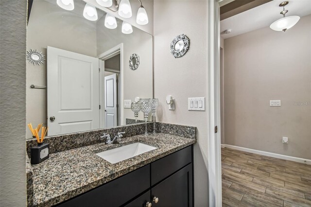 13201 Orca Sound Dr, Riverview, FL 33579 - bathroom featuring vanity, wood finished floors, and baseboards