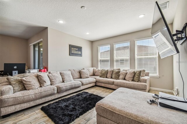 13201 Orca Sound Dr, Riverview, FL 33579 - living area with a textured ceiling, recessed lighting, light wood finished floors, baseboards, and an office area