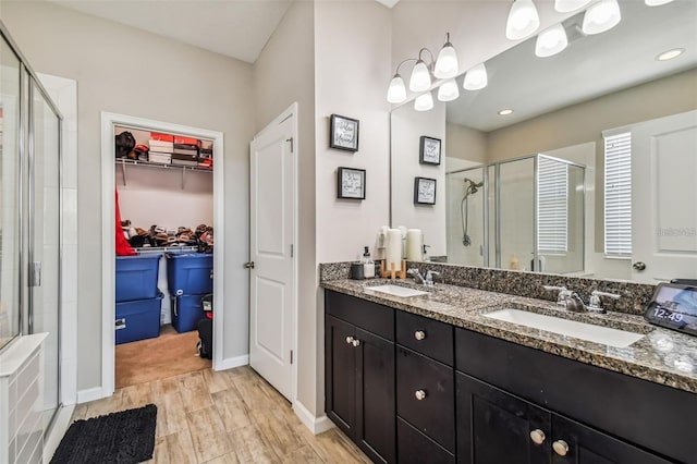 13201 Orca Sound Dr, Riverview, FL 33579 - full bathroom featuring a shower stall, a walk in closet, double vanity, and baseboards