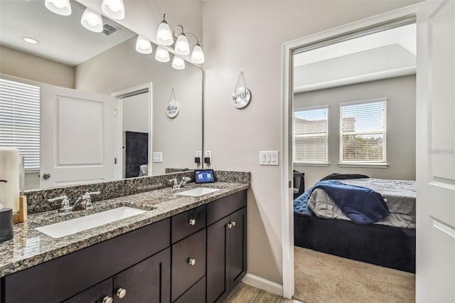 13201 Orca Sound Dr, Riverview, FL 33579 - ensuite bathroom with double vanity and baseboards