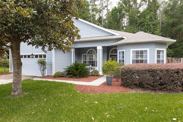 2072 SW 66th Dr, Gainesville, FL 32607 - view of front of home with a front lawn, an attached garage, roof with shingles, and driveway