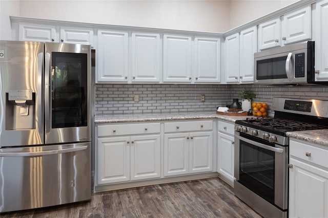 2072 SW 66th Dr, Gainesville, FL 32607 - kitchen featuring appliances with stainless steel finishes, white cabinets, decorative backsplash, and dark wood-type flooring
