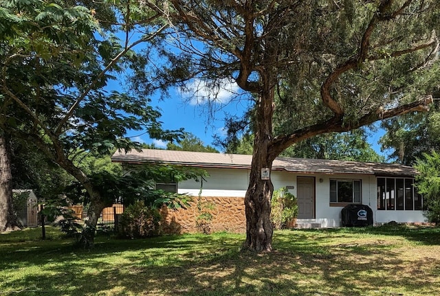 14230 SW 167th St, Archer, FL 32618 - view of front of home with a front yard and a sunroom