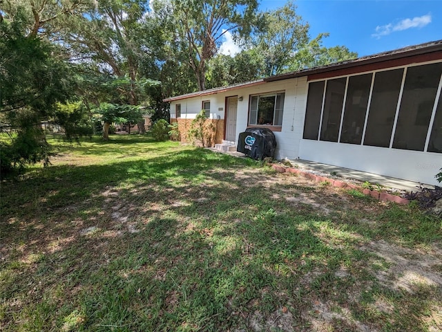 14230 SW 167th St, Archer, FL 32618 - view of grassy yard with a sunroom