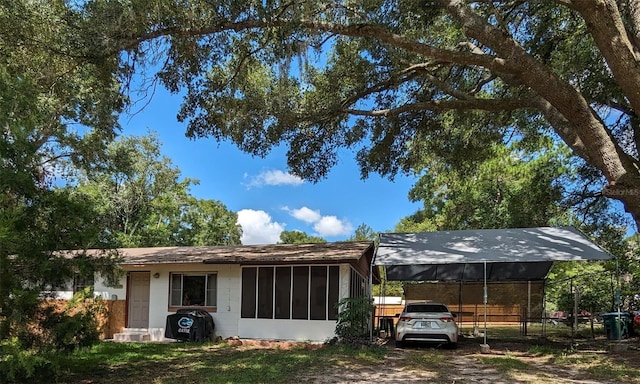 14230 SW 167th St, Archer, FL 32618 - back of house featuring a sunroom and a detached carport