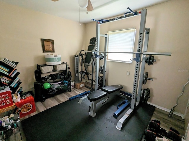14230 SW 167th St, Archer, FL 32618 - workout room featuring a ceiling fan, wood finished floors, and baseboards