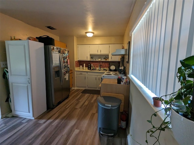 14230 SW 167th St, Archer, FL 32618 - kitchen featuring stainless steel fridge with ice dispenser, range hood, a sink, dark wood finished floors, and white cabinets