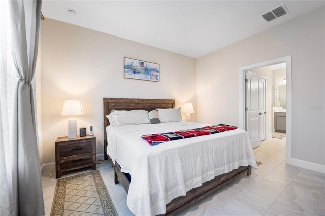 1192 Via Galuppi St, Poinciana, FL 34759 - bedroom featuring baseboards, light marble finish flooring, and ensuite bathroom