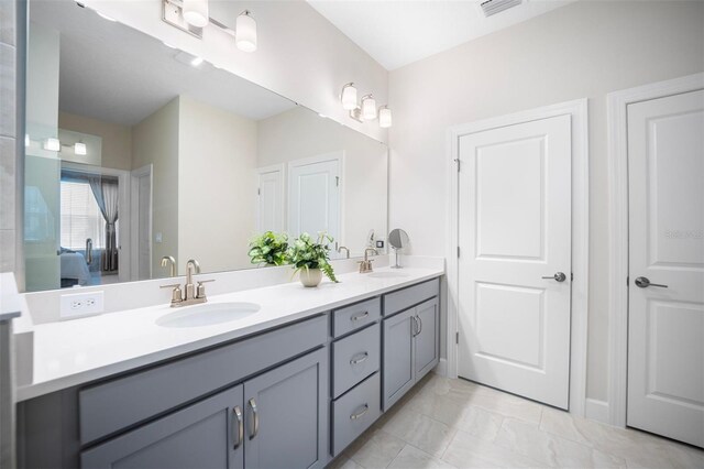 1192 Via Galuppi St, Poinciana, FL 34759 - bathroom featuring double vanity, ensuite bathroom, and marble finish flooring