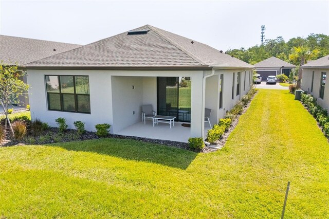 1192 Via Galuppi St, Poinciana, FL 34759 - rear view of property with stucco siding, a shingled roof, a yard, and a patio