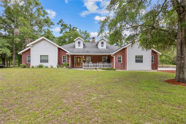 1827 SW Shiloh St, Fort White, FL 32038 - cape cod home with covered porch, brick siding, a front lawn, and a chimney