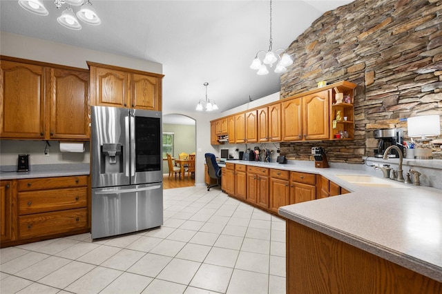 1827 SW Shiloh St, Fort White, FL 32038 - kitchen with stainless steel fridge with ice dispenser, a chandelier, a sink, light tile patterned floors, and brown cabinets