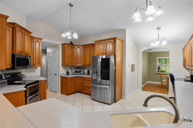 1827 SW Shiloh St, Fort White, FL 32038 - kitchen with stainless steel appliances, a chandelier, a sink, vaulted ceiling, and light countertops
