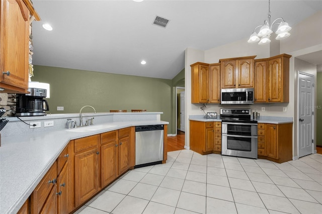1827 SW Shiloh St, Fort White, FL 32038 - kitchen featuring appliances with stainless steel finishes, a sink, light countertops, brown cabinetry, and vaulted ceiling