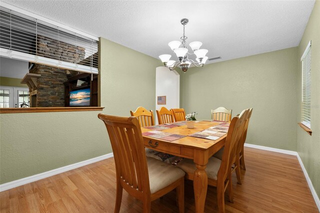 1827 SW Shiloh St, Fort White, FL 32038 - dining space with a chandelier, wood finished floors, and baseboards