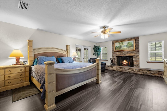 1827 SW Shiloh St, Fort White, FL 32038 - bedroom featuring a fireplace, french doors, access to outside, dark wood-style flooring, and a textured ceiling