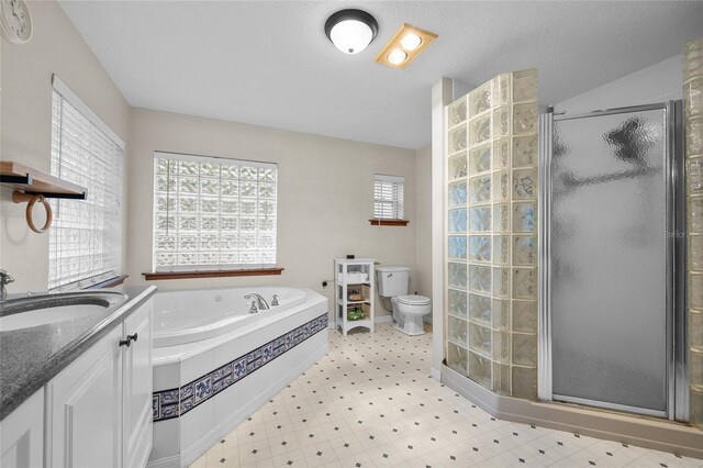 1827 SW Shiloh St, Fort White, FL 32038 - full bath featuring toilet, a stall shower, a garden tub, tile patterned floors, and vanity