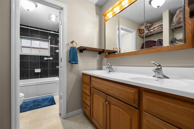 1827 SW Shiloh St, Fort White, FL 32038 - full bathroom featuring a textured ceiling, toilet, double vanity, tile patterned floors, and baseboards
