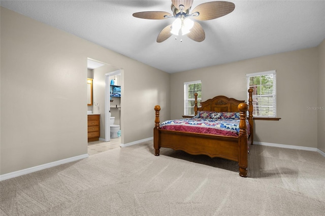 1827 SW Shiloh St, Fort White, FL 32038 - bedroom with light colored carpet, baseboards, multiple windows, and ensuite bath