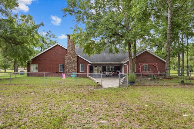 1827 SW Shiloh St, Fort White, FL 32038 - back of property with a patio area, a chimney, and brick siding