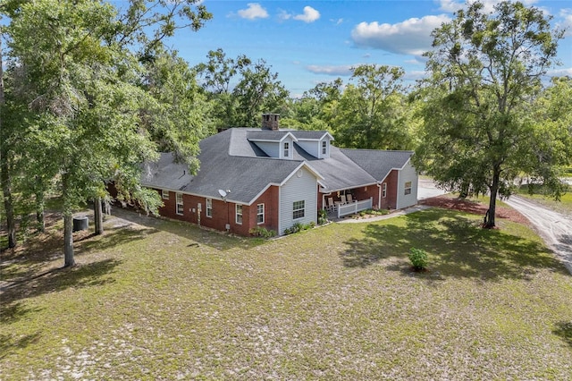 1827 SW Shiloh St, Fort White, FL 32038 - view of front of home with a front yard and a chimney