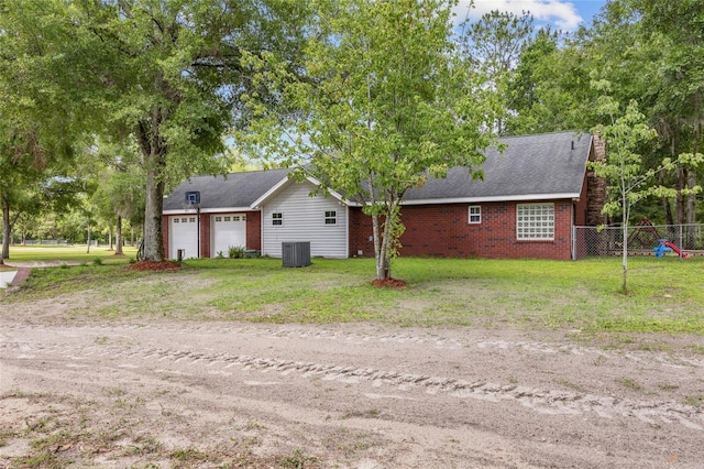 1827 SW Shiloh St, Fort White, FL 32038 - view of home's exterior featuring a garage, central AC, dirt driveway, and brick siding