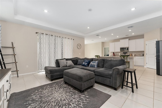 8123 SW 57th Ct, Ocala, FL 34476 - living area featuring a tray ceiling, light tile patterned floors, recessed lighting, and baseboards