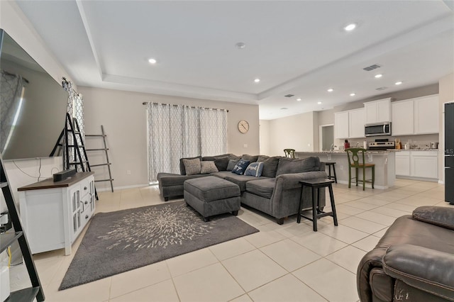 8123 SW 57th Ct, Ocala, FL 34476 - living room featuring light tile patterned flooring, a tray ceiling, recessed lighting, and baseboards