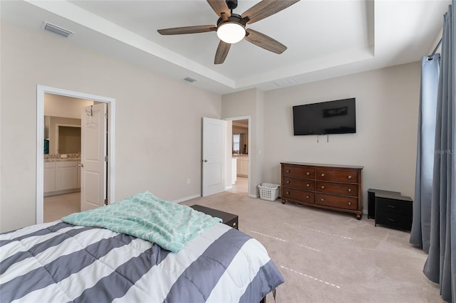 8123 SW 57th Ct, Ocala, FL 34476 - bedroom featuring light carpet, a tray ceiling, ceiling fan, and ensuite bathroom