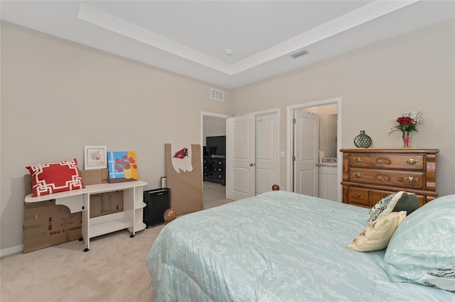 8123 SW 57th Ct, Ocala, FL 34476 - bedroom with light colored carpet, a raised ceiling, and connected bathroom