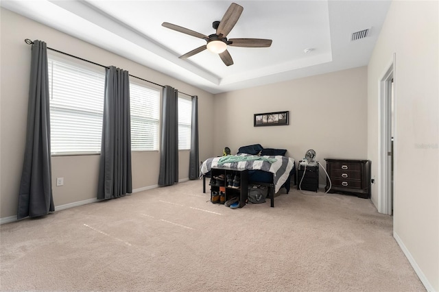 8123 SW 57th Ct, Ocala, FL 34476 - carpeted bedroom with a tray ceiling, baseboards, and ceiling fan