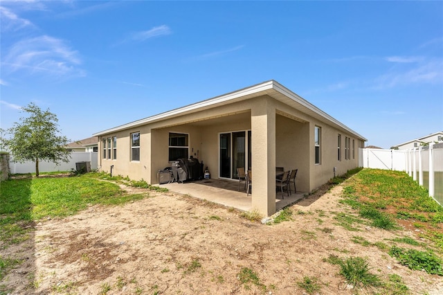 8123 SW 57th Ct, Ocala, FL 34476 - rear view of property with stucco siding, a fenced backyard, a patio area, and central air condition unit