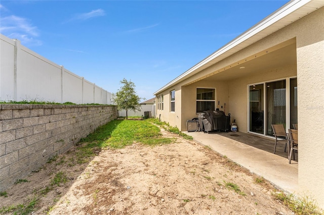 8123 SW 57th Ct, Ocala, FL 34476 - fenced backyard with a patio and central AC